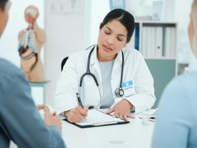 imgi_92_hospital-paperwork-doctor-with-couple-consulting-wellness-fertility-appointment-clinic-healthcare-gynaecologist-man-woman-medical-service-insu